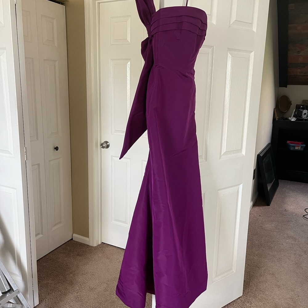 Oscar De La Renta strapless purple gown with bow.